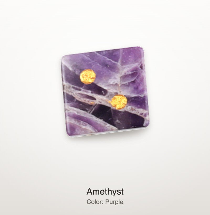 Luxury Mahjong 16mm amethyst stone dice with natural purple veining and bright gold pips on a white background
