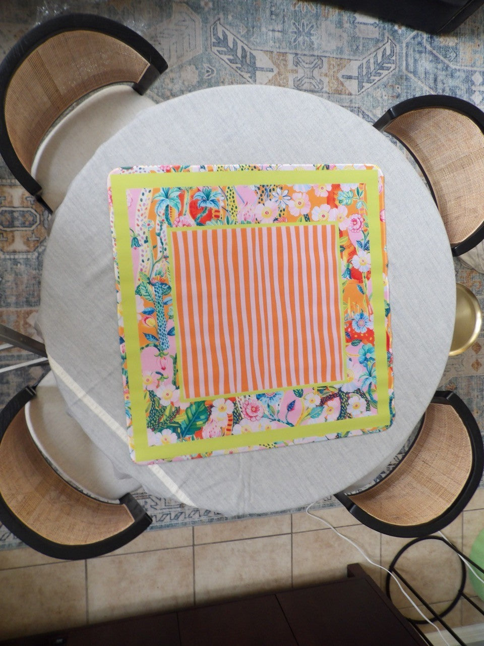 Orange striped mahjong mat with a chartreuse frame and a tropical floral border in pink, orange and blue