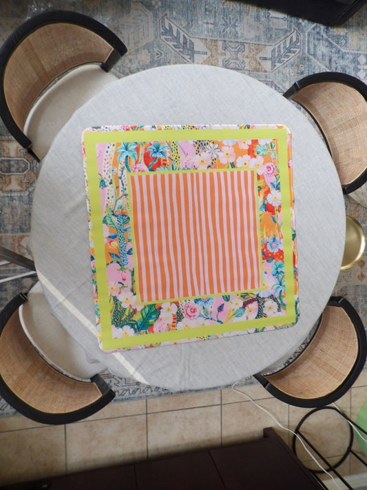 Orange striped mahjong mat with a chartreuse frame and a tropical floral border in pink, orange and blue