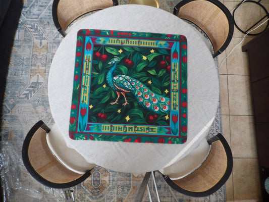 Teal peacock mahjong mat with a daisy-eyed tail on dark green foliage with red cherries and gold stars