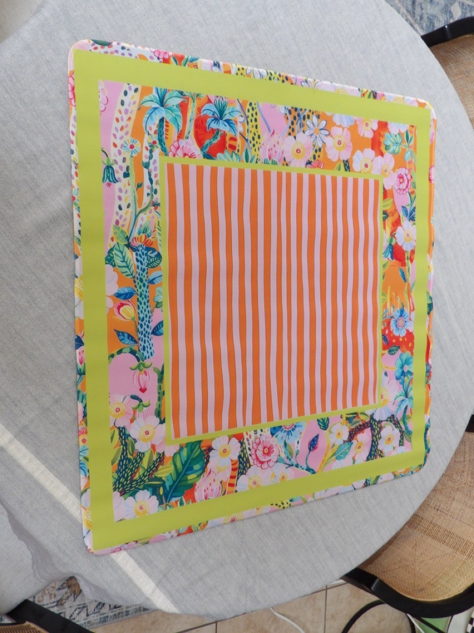 Close-up of the Cabana Bloom mahjong mat orange and pink candy stripe center panel