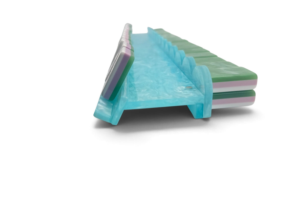 Aqua pearl scalloped mahjong rack holding a full hand of tiles
