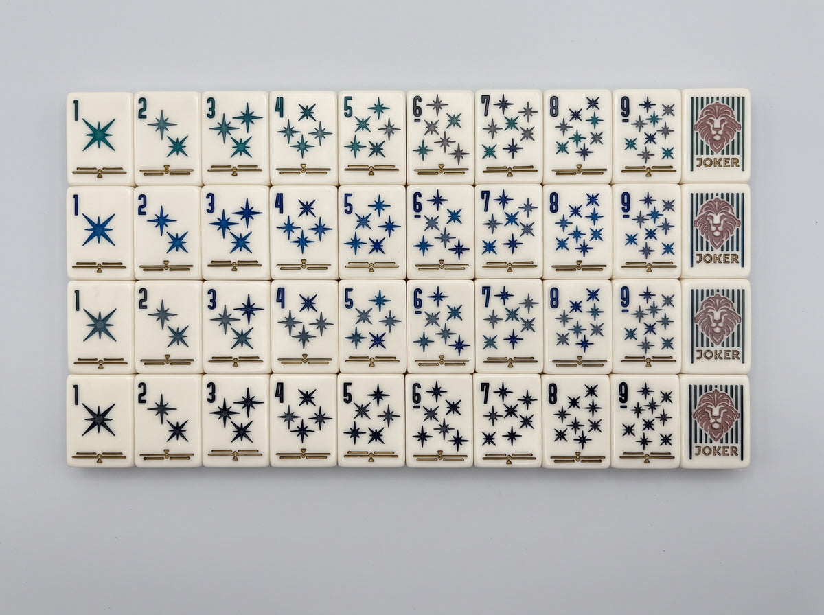 Deco Lion mahjong tiles with deep magenta backs and gold palmette fan detail.