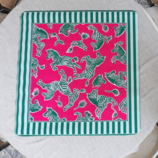 Hot pink mahjong mat with hand-drawn green zebras tumbling across the field and a green and white striped border