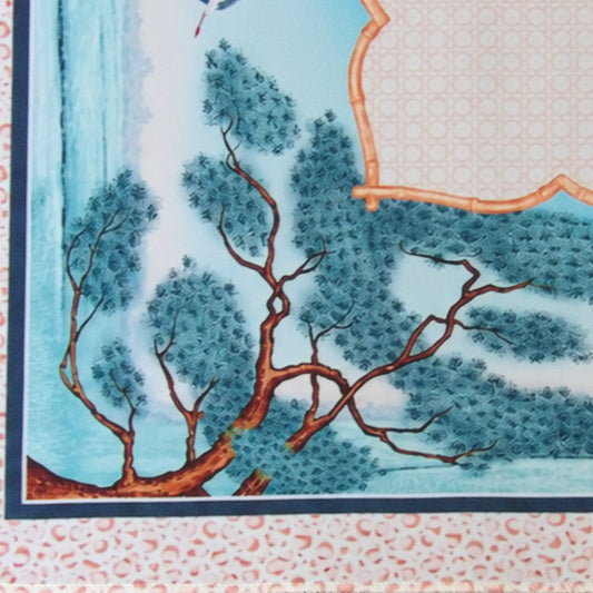 Close-up of the Willow Mist mahjong mat showing teal pine branches, misty water and the coral speckled outer border
