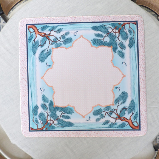 Pale blue chinoiserie mahjong mat with windswept pine trees, cranes and an orange bamboo cartouche border