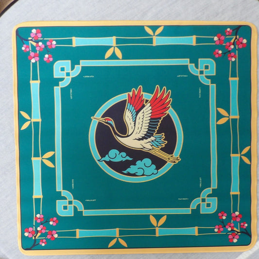 Emerald green mahjong mat with a red-crowned crane medallion, bamboo border and cherry blossom corners, laid flat