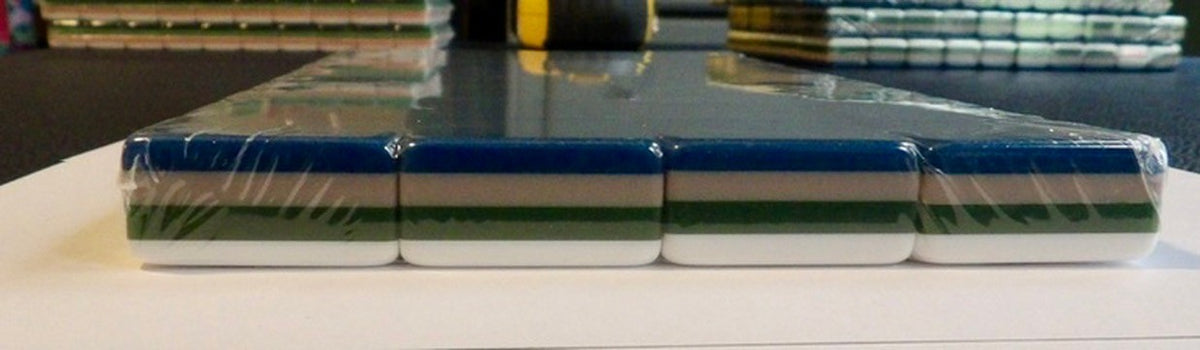Luxury Mahjong Blue Willow set showing the four-layered acrylic tile edges in navy, grey, green, and white.