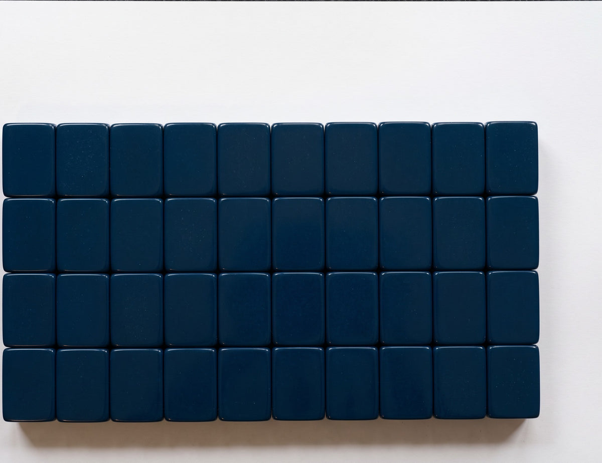 Luxury Mahjong Blue Willow set featuring deep navy acrylic tile backs arranged in a grid on a white surface