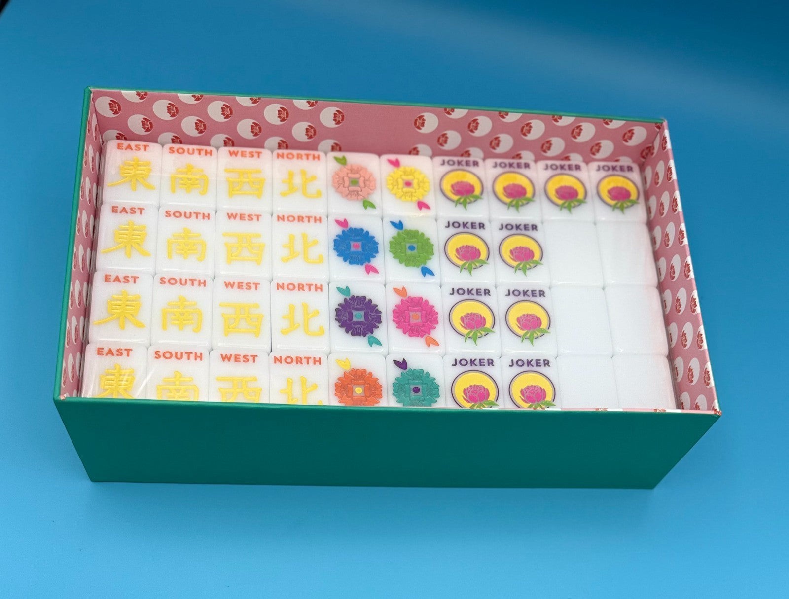 Luxury Mahjong The Brights! teal house tiles set featuring colorful floral designs and joker tiles in a patterned box.