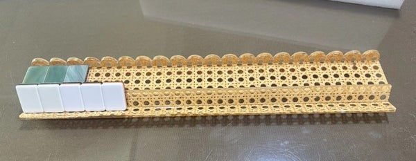 Luxury Mahjong 20-inch acrylic mahjong rack with woven cane inlay and scalloped magnetic pusher holding game tiles.