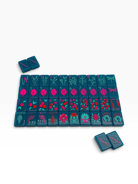 Luxury Mahjong Electric Bloom set featuring teal acrylic tiles with vibrant pink and green botanical illustrations.