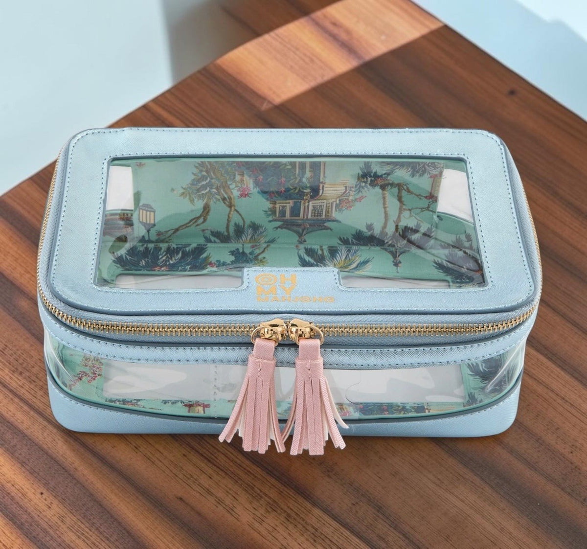 Luxury Mahjong metallic light blue storage case with clear lid, chinoiserie lining, gold hardware, and pink tassels.