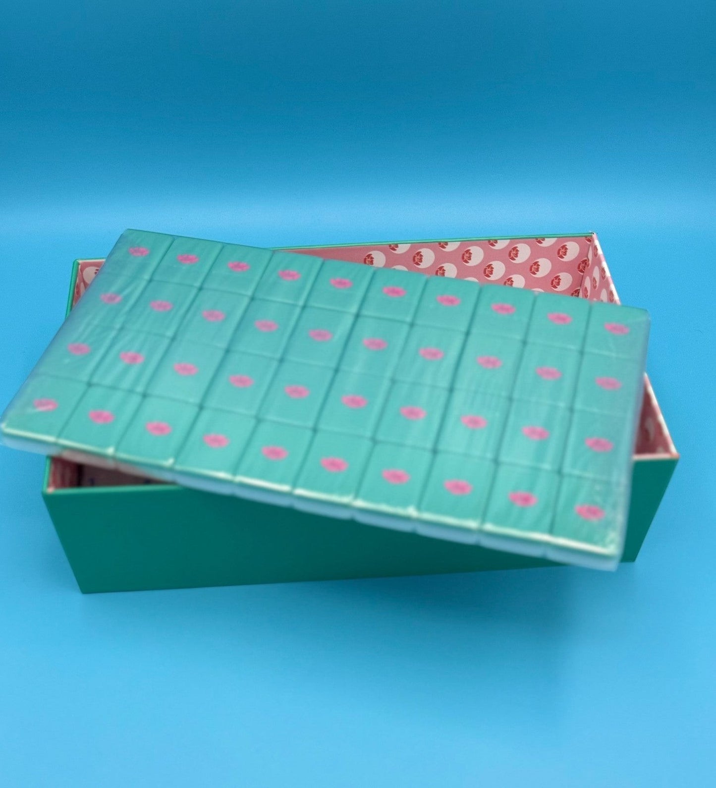 Luxury Mahjong The Brights! teal house tiles with pink accents in a matching storage box.