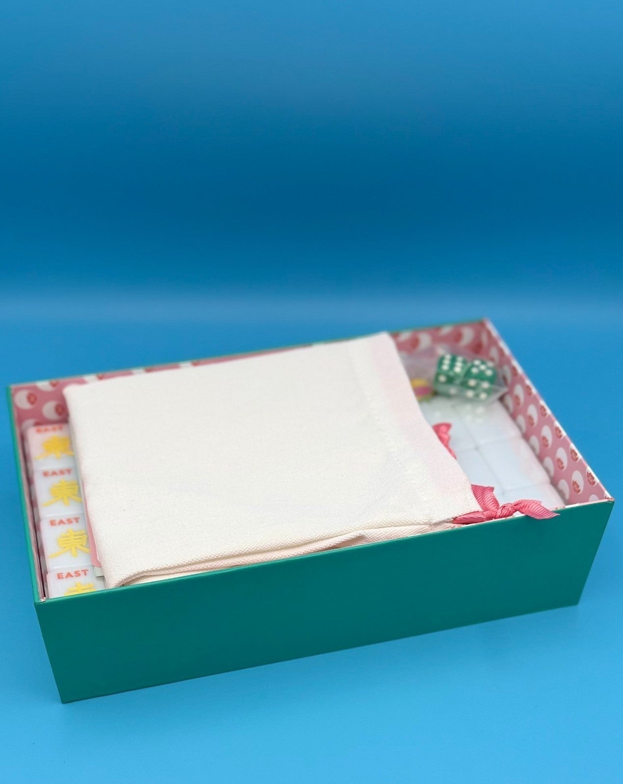 Luxury Mahjong The Brights! teal house tiles set in a decorative box with a white storage pouch and green dice.