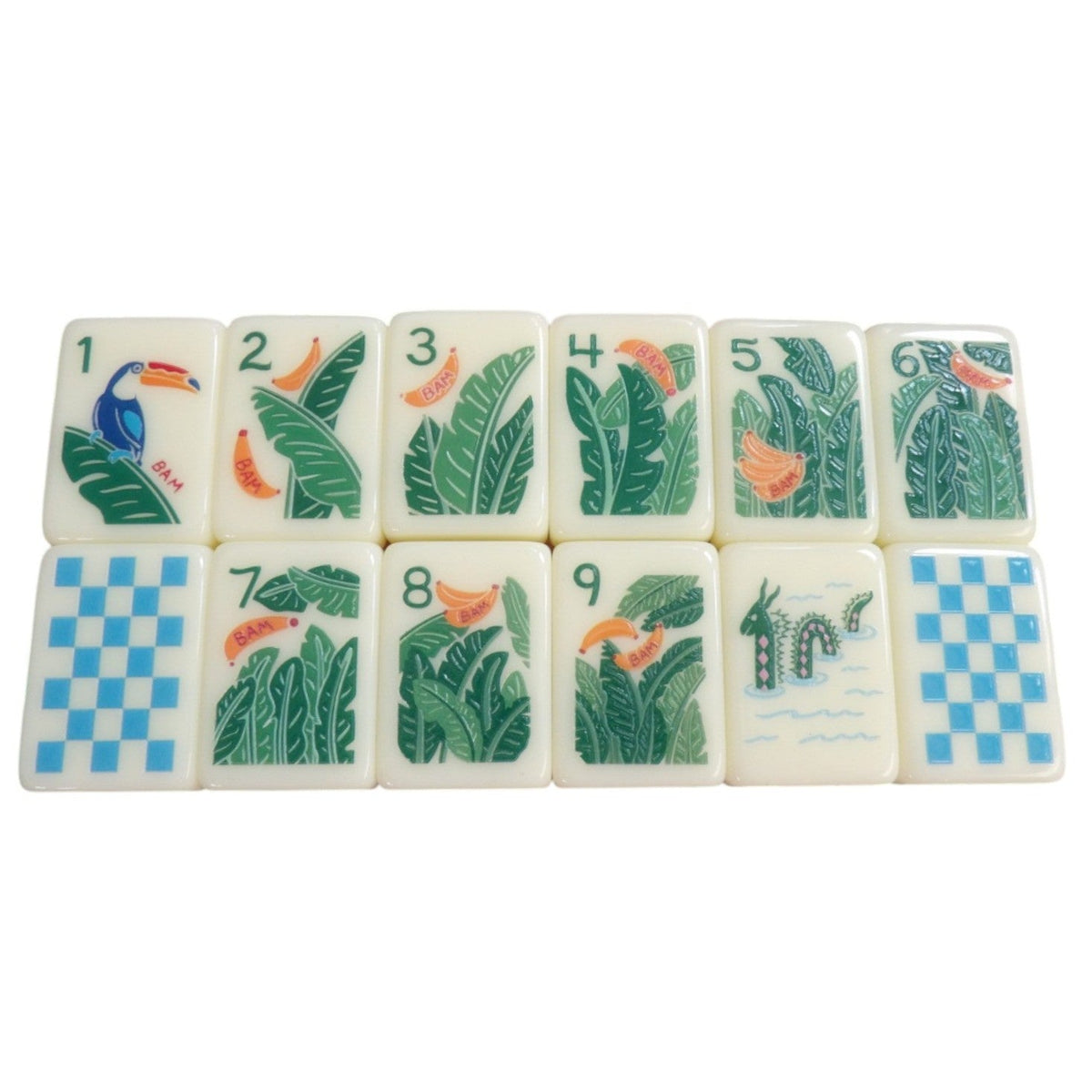 Luxury Mahjong tropical themed tiles featuring palm leaves, toucans, and bananas on smooth cream-colored surfaces.