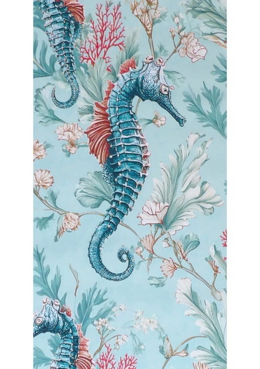 Close-up of the Seahorse Reef mahjong mat showing a teal seahorse, red coral and pale sea fronds on aqua